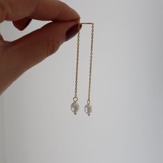 Elegance paired with romantic and you've got our pearl drop threaders. Adorned by a faux pearl sitting on a dainty chain earring. This threader is the perfect addition to any night out. If you have more than one piercing, try something fun and loop it through the second piercing! -stainless steel, gold plated Dainty Threader Earrings With Pearl Chain, Dainty Adjustable Threader Earrings With Pearl Drop, Adjustable Gold Threader Earrings With Pearl Drop, Delicate Pearl Drop Threader Earrings, 14k Gold-filled Pearl Drop Threader Earrings, Second Piercing, Chain Earrings, Pearl Drop Earrings, Pearl Drop