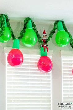 green and red christmas lights hanging from the ceiling