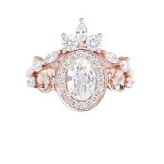 a rose gold ring with an oval cut diamond surrounded by smaller round diamonds