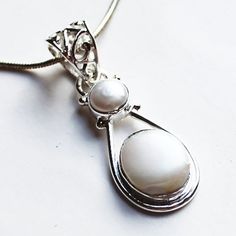 "This hand-crafted semi-precious stone pendant which features a gorgeous white Pearls set in solid 925 sterling silver. Stone: Pearl   Colour: White  Metal: 100% Solid Sterling Silver Pendant Size: 3 x 1.2 (Excluding Bail) Chain: 18\" solid sterling silver Materials: Each one-of-a-kind piece of jewellery is lovingly hand crafted using top quality semi-precious natural gemstones and solid 925 sterling silver, so that you can treasure your piece for a lifetime.  Gift Boxes: each unique piece is al Spiritual Sterling Silver Jewelry With Pearl Pendant, White Round Pendant Fine Jewelry, White Polished Finish Round Pendant Jewelry, Sterling Silver Pearl Pendant Fine Jewelry, Sterling Silver Fine Jewelry With Pearl Pendant, Sterling Silver White Gold Jewelry With Pearl Pendant, White Gold Sterling Silver Pearl Pendant Jewelry, White Gemstone Pendant Jewelry, Mother Of Pearl Gemstone Jewelry For Anniversary