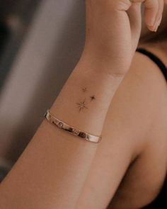 a woman with a small star tattoo on her wrist