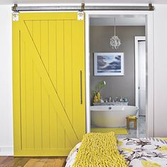 a bedroom with yellow sliding doors and a bathtub