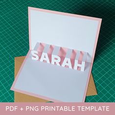 a card with the word sarah cut out on top of it, sitting next to some envelopes