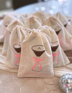 several bags with drinks in them sitting on a table next to a golf ball and tee