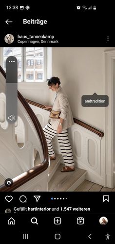 a woman in striped pants is walking up the stairs