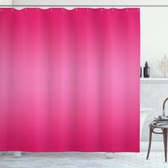 a bathroom with a pink shower curtain and white tub in the corner, next to a chair