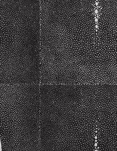 a black and white photo with dots on the fabric, taken from above looking down at it