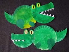 two paper plates shaped like crocodiles with their mouths open