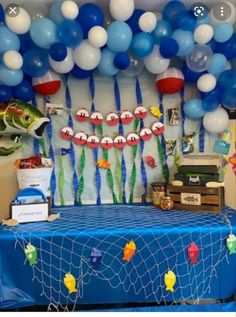 a table with balloons and fish on it