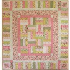 a pink and green quilt with squares on it