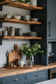 the shelves in the kitchen are filled with plates and bowls, cutting boards, and flowers