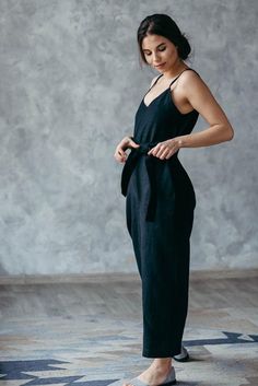 This timeless black linen jumpsuit will make you look effortless. Wide-fitting and made from comfortable, breathable soft washed linen fabric, this black jumpsuit is detailed with a tie belt at the waist to add shape (if you want to). These summer overalls are perfect for a busy day in the city and a quiet coffee date.***The Prancing Hare is the sister brand of Bunny Street, which was launched by Irene Sheyko in 2013. Drawing inspiration from there, The Prancing Hare boasts earthy, neutral aesth Black Linen Jumpsuits And Rompers For Summer, Fitted Linen Jumpsuits And Rompers For Loungewear, Black Linen Jumpsuit, Bohemian Jumpsuit, Linen Dressing Gown, Linen Gown, Jumpsuit Linen, Summer Overalls, Black Bohemian