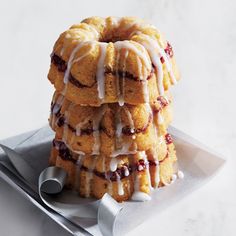 a stack of bundt cakes sitting on top of a white plate covered in icing