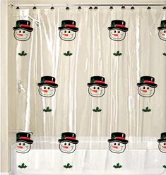 a shower curtain with snowmen wearing top hats and holly leaves on the bottom, in front of a white background