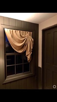 an open window with curtains hanging from it's sides