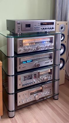 a stack of stereo equipment sitting on top of a wooden floor