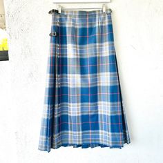 An authentic Scottish Kilt classic plaid skirt with the perfect pleats and classic belt closures in superb condition. Very unusual to see it a blue color! S p e c i f i c s . . . Label: Edinburgh Old Town Weaving Co. Tagged Size: 28 Approx. Fit: S Material: Pure Wool Woven Material // Leather Belt Closure  Color: Blues // Peach // Yellow // White  Condition: Overall in Amazing Vintage Condition (Pristine condition!! And the finest quality, appears to never been worn!) M e a s u r e m e n t s . . Classic Pleated Plaid Skirt, Classic Blue Pleated Bottoms, Classic Blue Denim Skirt, Fitted Belted Blue Skirt, Fitted Blue Belted Skirt, Blue Fitted Belted Skirt, Classic Belt, Scottish Kilts, Blue Peach