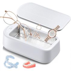 a pair of glasses sitting on top of an ice tray next to a toothbrush