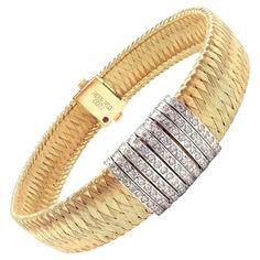 The Roberto Coin 18k Yellow Gold 9 Row Diamond Silk Weave Bracelet is an exquisite piece of jewelry. It features nine rows of diamonds set in 18k white gold bars. These bars are set on a basketweave design to resemble silk, entirely crafted from 18k yellow gold. Each row of bars are delicately adorned with sparkling diamonds, adding a touch of elegance and luxury. The bracelet's clasp is hidden, maintaining the seamless design, and it bears the signature Roberto Coin ruby, discreetly placed for Diamond And Silk, Weave Bracelet, Gold Bars, Gold Armband, Tourmaline Bracelet, Enamel Bangle, Roberto Coin, Bangle Bracelets With Charms, Woven Bracelets