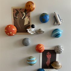 there are many different objects on the wall in this room, including balls and magnets