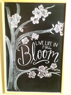 a chalkboard with the words live life in bloom written on it