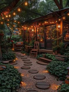 an outdoor patio with lights strung from the ceiling and stepping stones on the ground in front of it