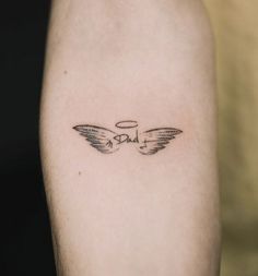 a small tattoo on the arm of a person with an angel wing and word love