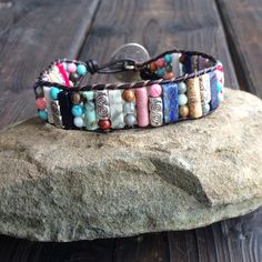 This multi color beaded bracelet for women is stunning and unique. This single wrap bracelet would compliment and outfit you want to wear it with. This bracelet would be a beautiful meaningful gift for your mother on Mother's Day. It will be a gift she can enjoy every day. This leather beaded bracelet is made with a variety of gemstone beads in various sizes and colors. Please choose the size you would like at check out. Adjustable Multicolor Artisan Wrap Bracelet, Multicolor Natural Stones Friendship Bracelets, Bohemian Multicolor Round Beads Wrap Bracelet, Artisan Adjustable Wrap Bracelet For Gift, Multicolor Beaded Spiritual Leather Bracelet, Artisan Beaded Multicolor Wrap Bracelet, Artisan Adjustable Wrap Bracelet Gift, Artisan Multicolor Beaded Wrap Bracelet, Bohemian Braided Bracelet With 8mm Beads As Gift