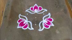 a flower design on the ground with white and pink flowers painted on it's side