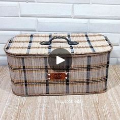 an old suitcase sitting on top of a wooden floor next to a white brick wall