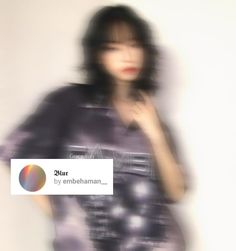 a blurry photo of a woman wearing a t - shirt with an emebhan logo on it