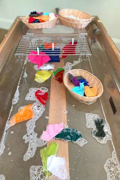 a glass table topped with lots of different colored items