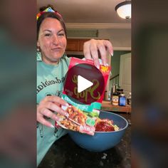 a woman pouring ketchup into a bowl filled with food