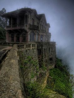 an old house on the edge of a cliff