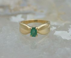 "14K Yellow Gold Emerald Ring, 4x6mm emerald cut natural lightly included folded ribbon form top, Ring size 6.5, 1/4\" across, weight 3.86 grams Stock # BRT135R06 This listing contains photographs of the actual item you will receive. Our items are in excellent condition with little or no signs of wear and many are one of a kind pre-owned estate finds. Please look closely at the pictures in this listing as they are part of the product description. Please read the description, as any imperfections Gold Emerald Ring, Emerald Ring Gold, Emerald Gem, Fine Jewelry Designers, Yellow Gold Earring, Boston Ma, Size 10 Rings, Blue Topaz Ring, Topaz Ring