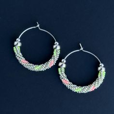 Silver and Neon glass beads woven over sterling silver wire. Lightweight and blacklight reactive! Miyuki Glass Beads Sterling Silver Length 1 inch Handmade in Tucson, AZ Silver Beaded Hoop Earrings For Gift, Colorful Beads Jewelry Gift, Silver Hoop Earrings With Colorful Beads As Gift, Nickel Free Green Small Hoop Beaded Earrings, Small Silver Hoop Earrings With Colorful Beads, Silver Small Hoop Earrings With Colorful Beads, Handmade Neon Jewelry For Gift, Neon Jewelry With Colorful Beads As A Gift, Green Nickel-free Small Hoop Beaded Earrings