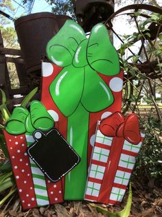 some candy canes are wrapped in green and red wrapping paper with bows on them