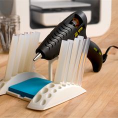 a pair of scissors are being used to sharpen plastic strips on a table top