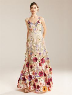 a woman in a long dress with flowers on it