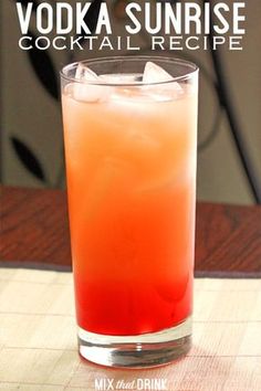 an orange and red drink sitting on top of a wooden table