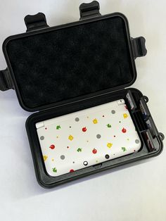 an open black case with colorful designs on it