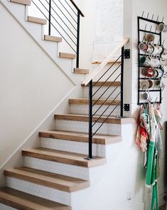 there is a set of stairs in the house with shoes hanging on the wall next to it