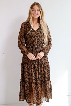 The Graceful Glamour Black Floral Midi Dress is the perfect pick for any elegant evening! This enchanting dress features a stunning floral design in warm brown tones against a sleek black background, creating a beautiful contrast that's perfect for any occasion. The long sleeves add a touch of elegance and warmth, making it ideal for cooler days or evening events. Designed with a flattering midi length, this dress drapes gracefully, allowing for easy movement while maintaining a chic silhouette. Floral Midi Dress Wedding, Midi Dress Wedding, Black Floral Midi Dress, Midi Dress Wedding Guest, Enchanting Dress, Dress Drape, Dress Wedding Guest, Brown Tones, Flowing Skirt