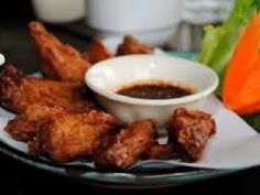 chicken wings and dipping sauce on a plate