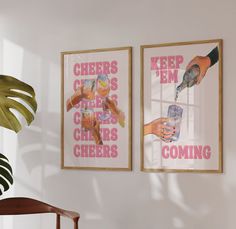 two posters hanging on the wall next to a chair and potted plant in front of them