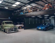 two cars parked in a garage next to each other