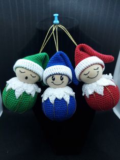 three crocheted christmas ornaments hanging from a hook