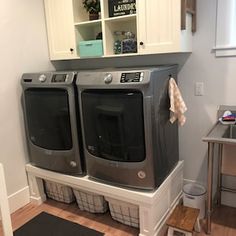 a washer and dryer sitting in a laundry room next to each other on the floor