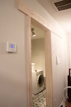 a washer and dryer sitting in a room next to each other on the wall