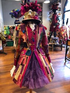 an elaborate dress and hat on display in a store